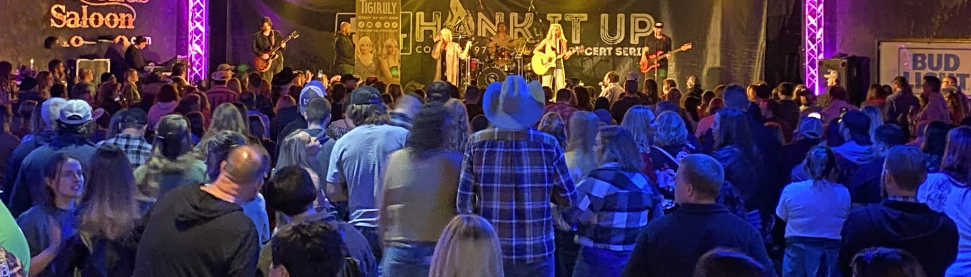 country concert with fans wearing cowboy hats Ames