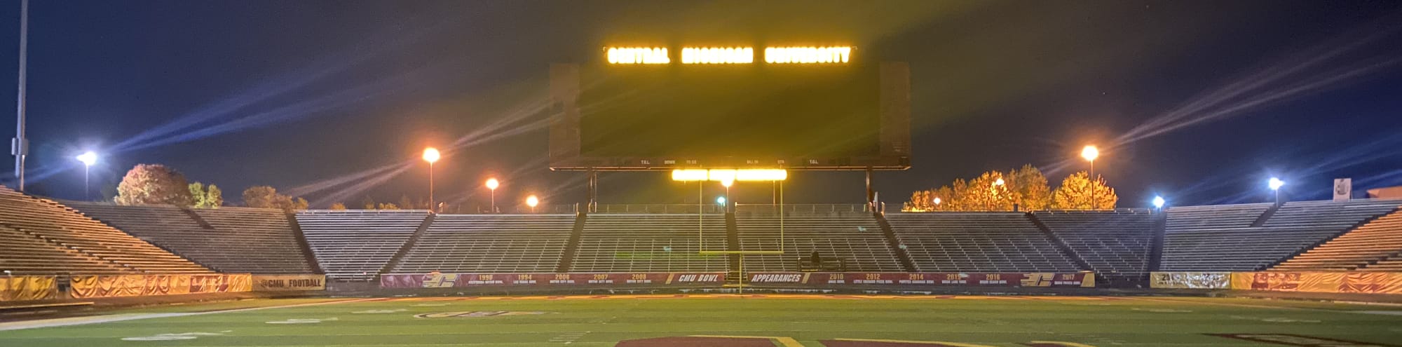 empty football stadium at night under the lights Ames